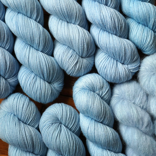 Close-up of blue skeins of yarn on a wooden surface