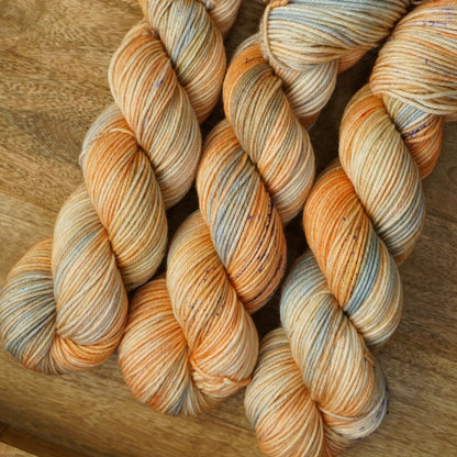 Multicolored yarn skeins on a wooden surface